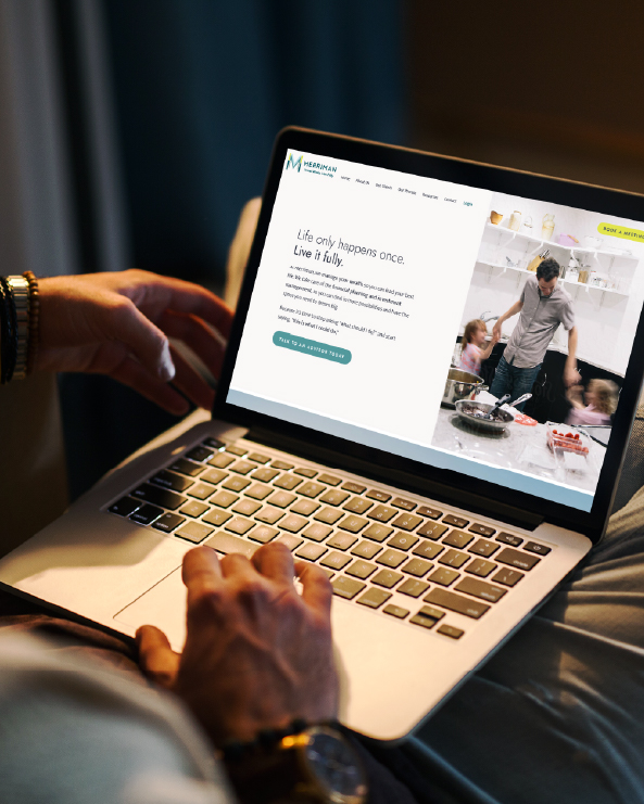 Person using a laptop with a webpage open showing a person and children in a kitchen, text on the screen, and a dark background.