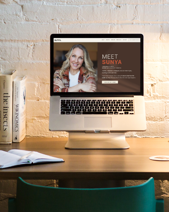 Laptop on desk displaying a website with a woman smiling and text that says 'Meet Sunya'.