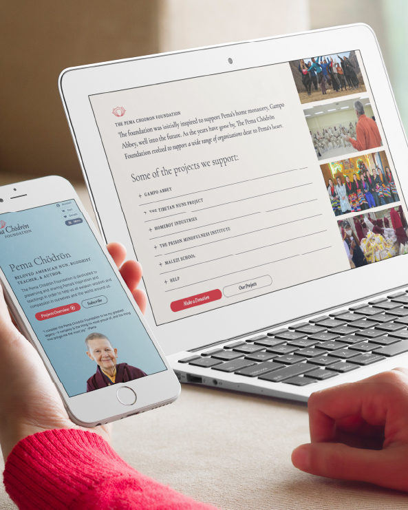 Person holding a smartphone displaying a certificate, with a laptop showing a presentation slide and photos in the background.