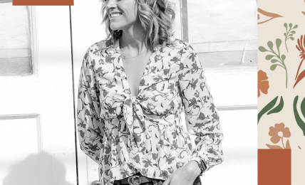 Woman smiling, standing indoors with windows in background, wearing floral blouse and jeans, surrounded by decorative shapes.