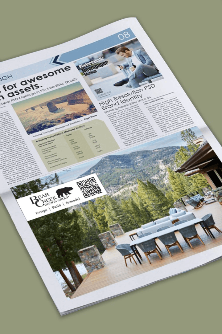 A newspaper page with articles, images, and a QR code, placed on a green surface, showing outdoor furniture and landscape.